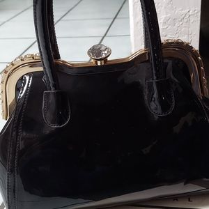 Black purse with rhinestone fastener
